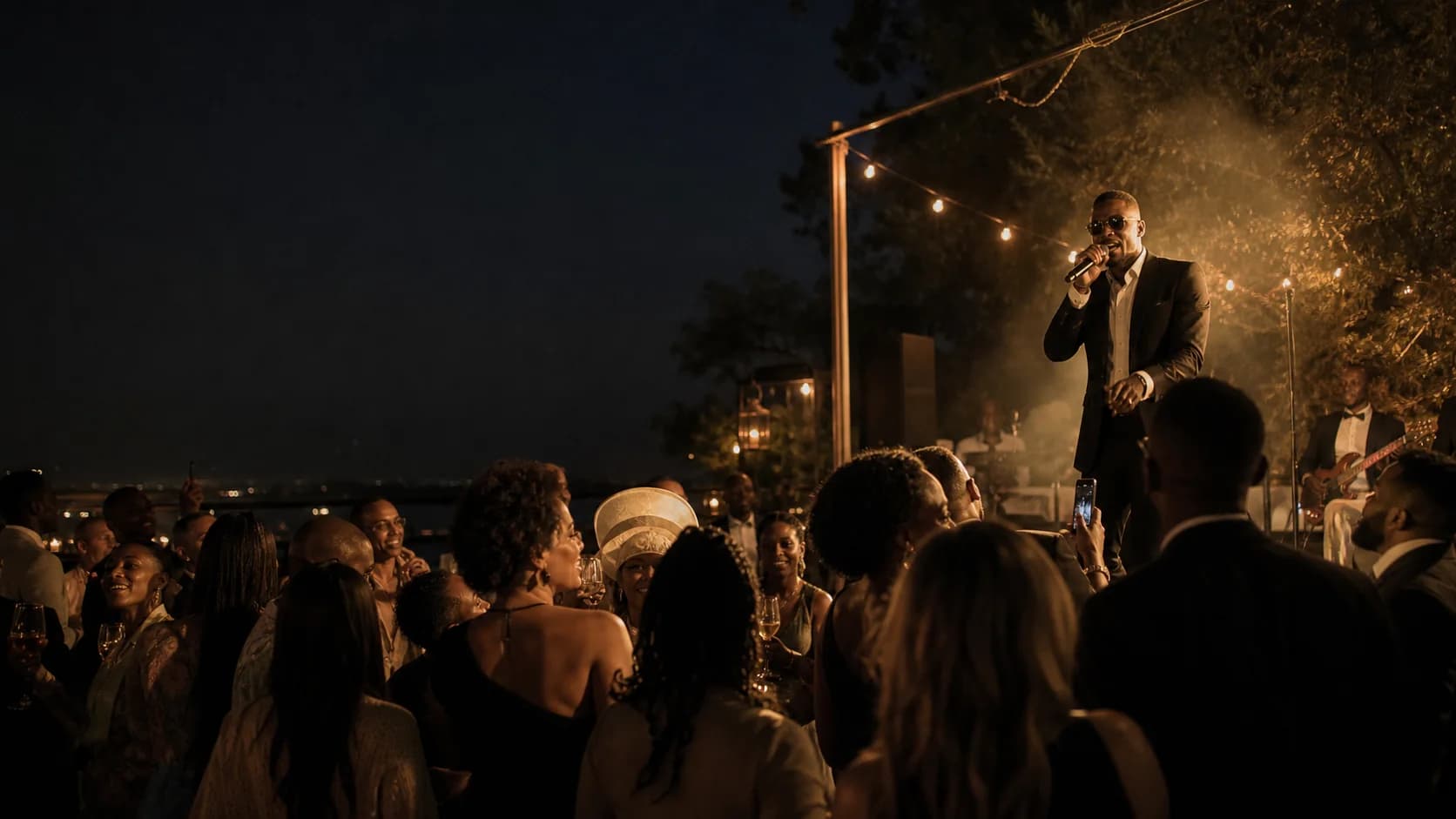Guests watching a live performer at a South African evening event